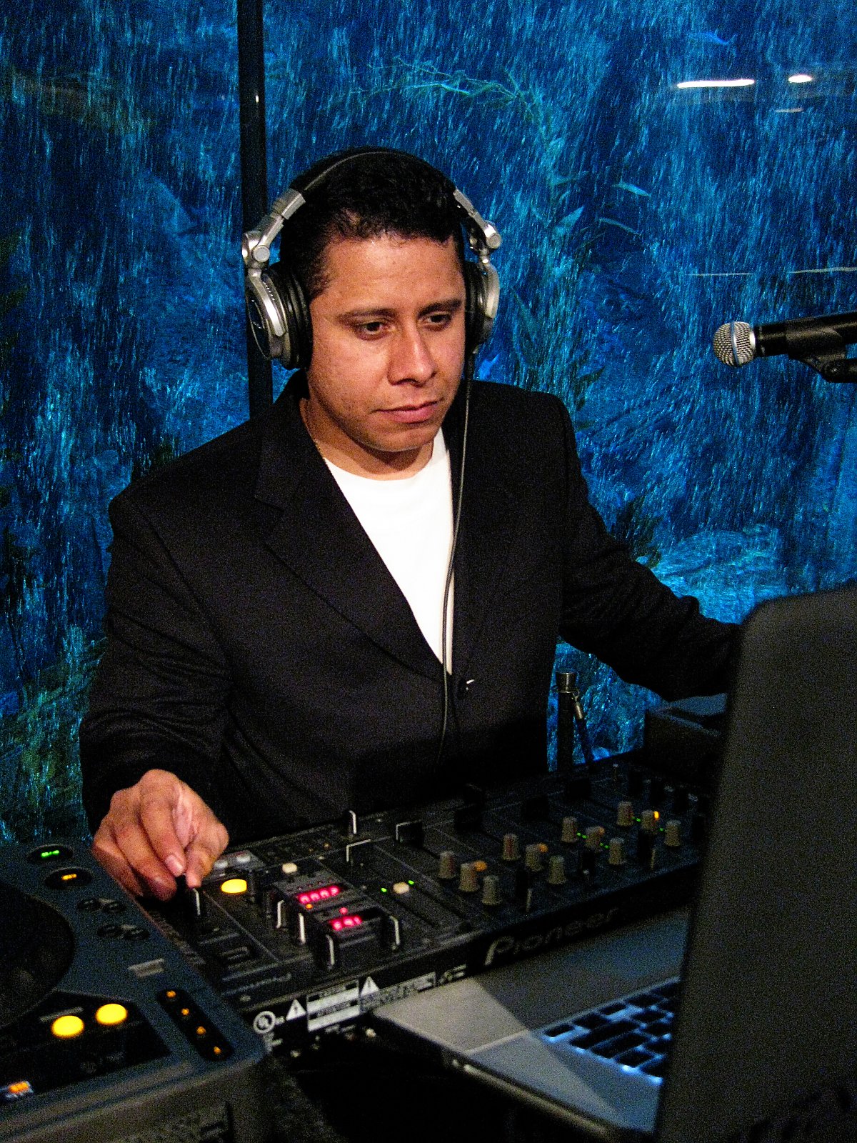 DJ Quinto Sol playing music in front of Aquarium exhibit