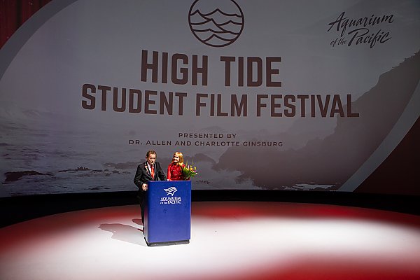 Two people at podium with High Tide Student Film Festival in background