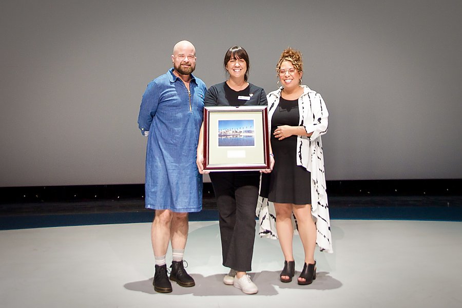 Three people holding award